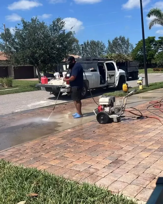 Mr Pressure Wash cleaning a paver driveway, truck and equipment on site